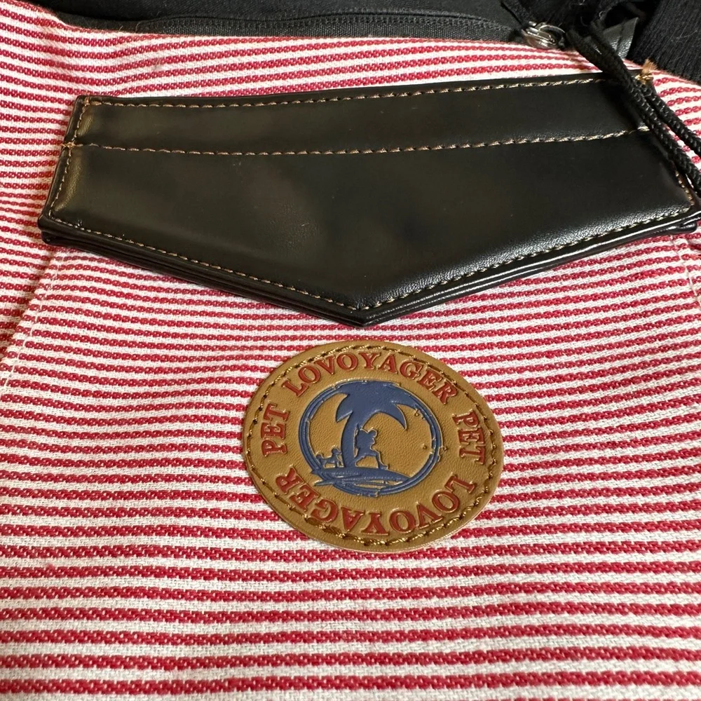 Pet carrier bag strap has a cell phone holder. The strap is padded like new.